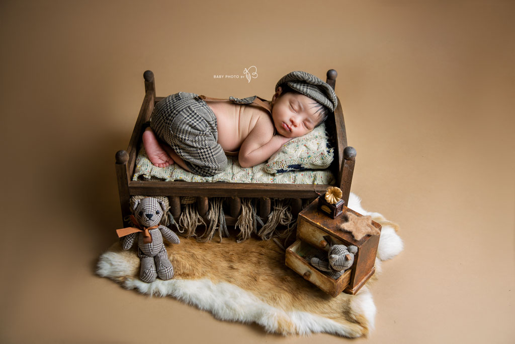 newborn baby boy in little crib